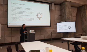 A person presenting at the front of a room