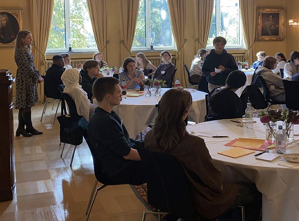 a group of young people sit for a plenary sessions