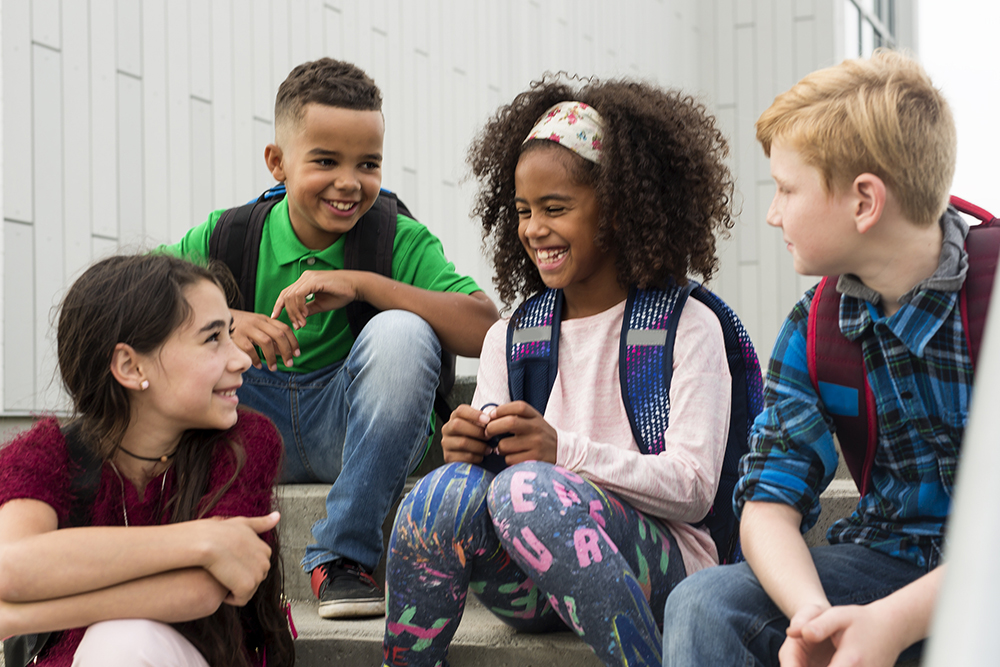 image of children sat talking and laughing