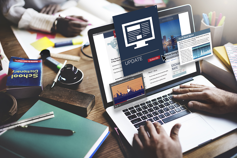 image of person at a laptop checking the news online