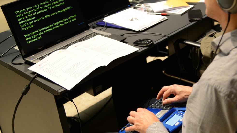 young student using assistive technology at an event