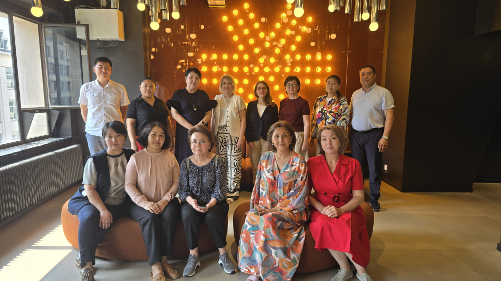 The Kazakhstani delegation, together with EASNIE’s Antonella Mangiaracina and Director of the Belgian Education Council, Axana Pozdyakiova. The delegation grouped together in front of a wall of lights arranged in a star shape