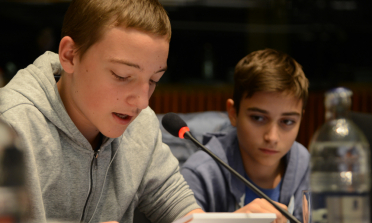 Young people speaking in the plenary session