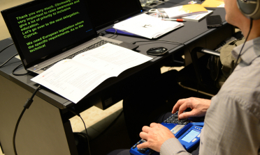 young student using assistive technology at an event