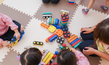 A group of children playing with building blocks