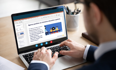 A man looks at a laptop screen with the Agency information displayed on it