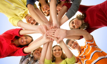 young people forming a circle with their hands