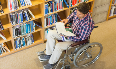 young person in a wheelchair in a university library