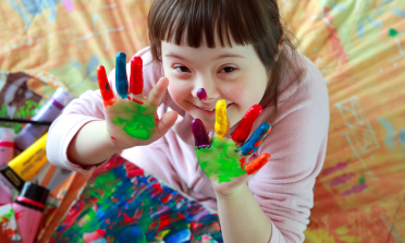 young child playing with paint