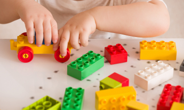 young children playing with colourful lego