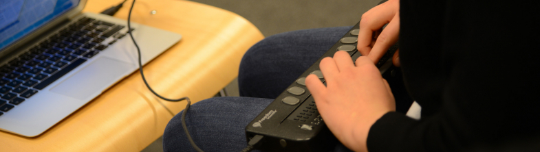 image of a young person using assistive technology