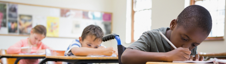 Children working at desks in a classroom