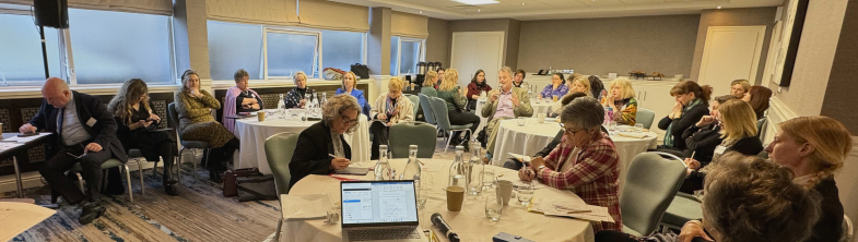 Stakeholders listening to a presentation in a conference room