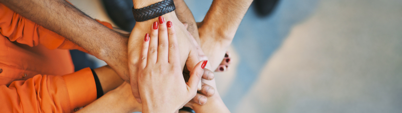 Six people's hands joined together