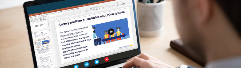 A person working on a laptop with the Agency position on inclusive education systems visible on the screen