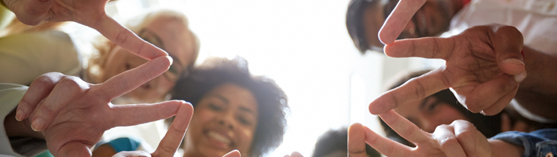 a group of young people touching hands
