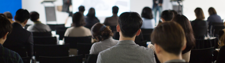A group of people watching a presentation