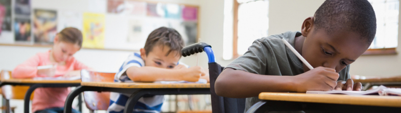 schoolchildren sitting at their desks