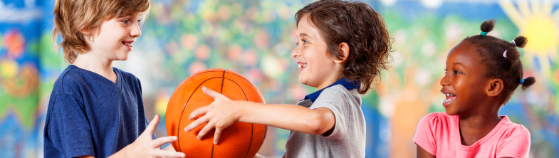 boy offering a ball to another child