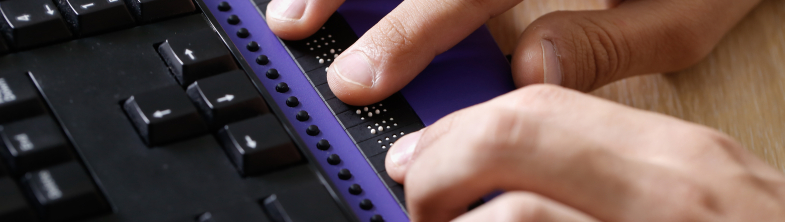 Hands using a Braille keyboard