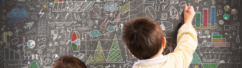 Two children draw on a blackboard covered in graphs and notes