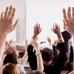 People hold their hands in the air
