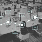 Children in a classroom, sitting in front of rows of computers. Overlaid on the image is a line graph, showing a range of percentages.