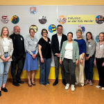 A group of people standing in a school hall