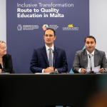 Three people presenting in front of an audience