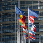 EU and member state flags fly outside the European Parliament building