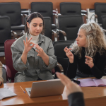 A group of young people communicate using sign language