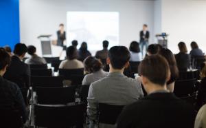 A group of people watching a presentation